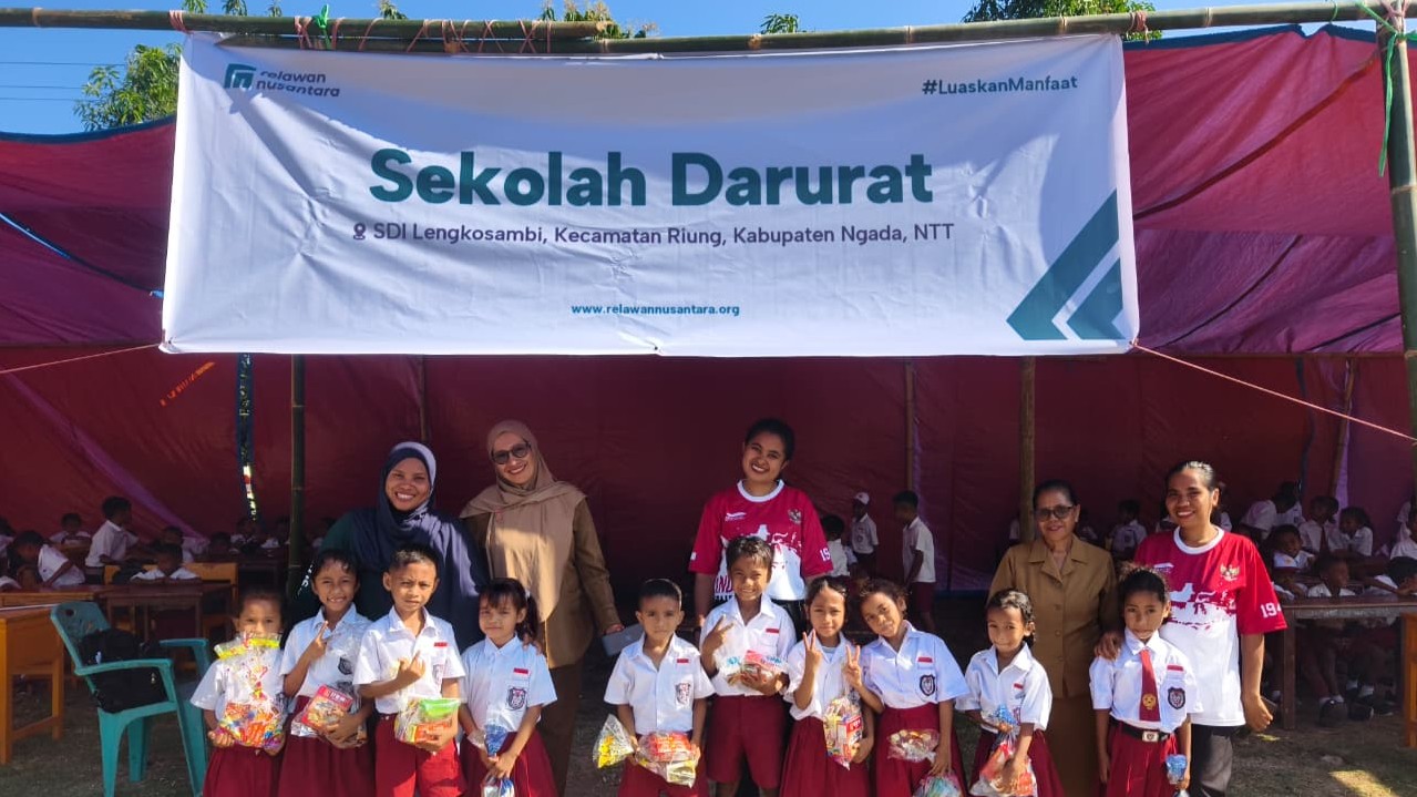 sekolah-darurat-sdi-lengkosambi-relawan-nusantara Siswa dan guru foto bersama di depan spanduk sekolah darurat SDI Lengkosambi buatan Relawan Nusantara.